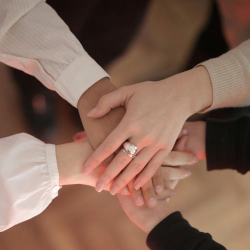 hands stacked on top of each other in a huddle